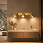 Bild in die Galerieansicht laden, Brass three-head adjustable wall light over a bathroom vanity