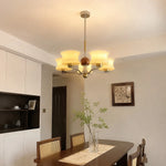 Cargar imagen en el visor de la Galería, Cream glass chandelier over a dining table