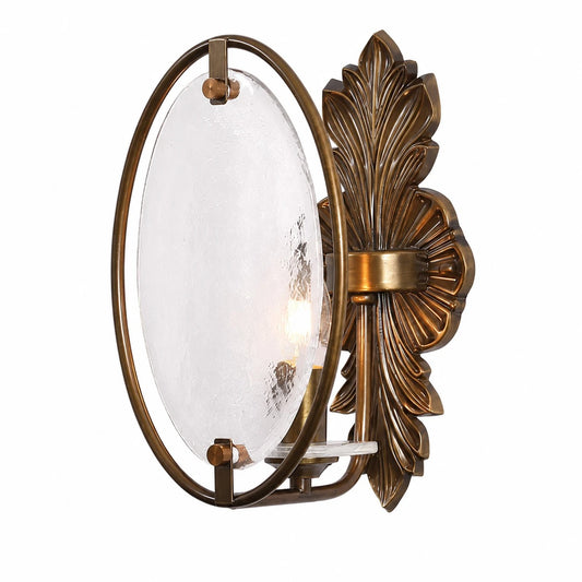Side view of antique brass wall sconce with oval textured glass shade