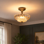 Załaduj obraz do przeglądarki galerii, Fluted glass ceiling fixture glowing in a dark paneled room