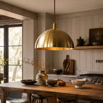 Load image into Gallery viewer, Half dome brass pendant light above a dining corner