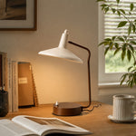 Bild in die Galerieansicht laden, Wabi-sabi iron desk lamp glowing beside notebooks and a ceramic mug