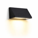 Załaduj obraz do przeglądarki galerii, Black wall light glowing on an exterior wall at night