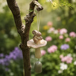 Afbeelding laden in galerijweergave, Warm ivory squirrel wind chime hanging in a garden setting