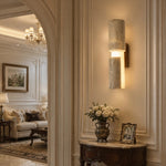 Załaduj obraz do przeglądarki galerii, Single travertine acrylic wall lamp installed beside a living room opening