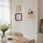 Cargar imagen en el visor de la Galería, Woven rattan wall sconce in a dining space