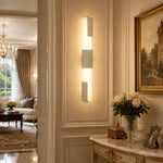 Załaduj obraz do przeglądarki galerii, Yellow travertine acrylic wall lamps installed as a vertical pair on paneled wall