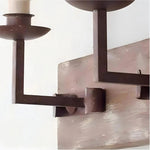 Bild in die Galerieansicht laden, Close view of the rustic dark metal candle arm and distressed wood backplate