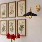 Cargar imagen en el visor de la Galería, Black wall sconce above framed botanical art