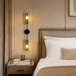 Carica l'immagine nella visualizzazione Galleria, Black copper two-head alabaster wall sconce installed beside a bed