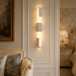 Załaduj obraz do przeglądarki galerii, Three-section travertine acrylic wall lamp on a paneled bedroom wall