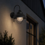 Load image into Gallery viewer, Black seeded-glass wall lamp creating a warm evening accent