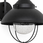 Load image into Gallery viewer, Seeded-glass globe beneath a black metal shade and cage