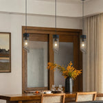 Cargar imagen en el visor de la Galería, Three black mesh stone pendant lights above a dining counter