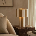 Carica l'immagine nella visualizzazione Galleria, Apricot striped table lamp lit on a marble side table beside a sofa