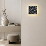 Cargar imagen en el visor de la Galería, Pair of carved travertine wall sconces installed on a modern wall