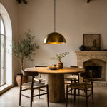 Load image into Gallery viewer, Brass dome pendant light above a round dining table