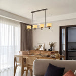 Cargar imagen en el visor de la Galería, Cream glass chandelier in a relaxed dining and living area