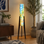 Carica l'immagine nella visualizzazione Galleria, Blue botanical tripod floor lamp illuminating a quiet interior