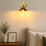 Load image into Gallery viewer, Wood and brass wall sconce installed in a warm bedroom