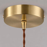 Cargar imagen en el visor de la Galería, Warm lit glass shade detail on brass pendant light
