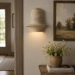 Załaduj obraz do przeglądarki galerii, Travertine wall sconce glowing beside artwork and a console vignette