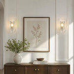 Afbeelding laden in galerijweergave, Clear glass wall sconce shown beside framed wall art