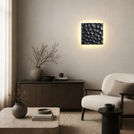 Cargar imagen en el visor de la Galería, Square travertine wall sconce used as bedside ambient lighting