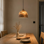 Cargar imagen en el visor de la Galería, Handmade paper pendant light glowing above a dining table