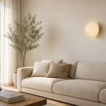 Cargar imagen en el visor de la Galería, Cream ribbed glass wall sconce in a quiet living room