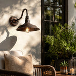 Cargar imagen en el visor de la Galería, Rustic wall light casting warm shadows outdoors