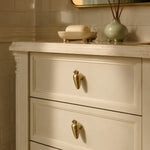 Afbeelding laden in galerijweergave, Brass rabbit and carrot cabinet knobs on a cream dresser