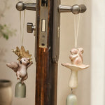 Afbeelding laden in galerijweergave, Two warm ivory squirrel wind chime styles hanging on a handle