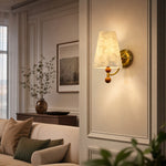Carica l'immagine nella visualizzazione Galleria, Capiz shell wall sconce glowing in an elegant paneled sitting room