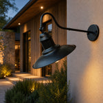 Załaduj obraz do przeglądarki galerii, Black outdoor wall sconce installed on a sheltered exterior wall