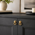 Afbeelding laden in galerijweergave, Brass ring pulls on a dark cabinet