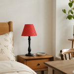 Afbeelding laden in galerijweergave, Red shade table lamp in a cozy bedroom setting