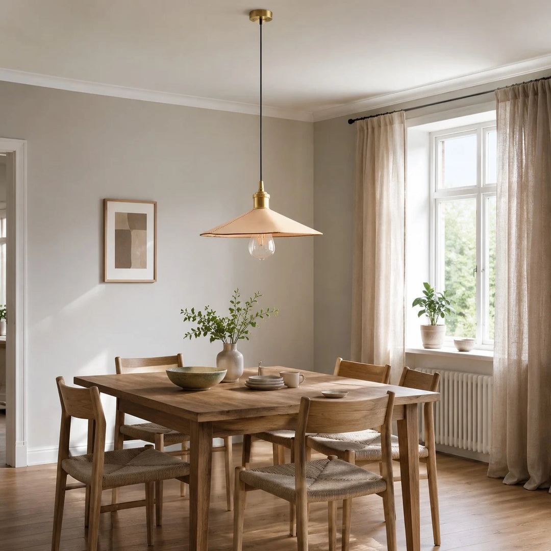 Leather cone pendant light above a dining table