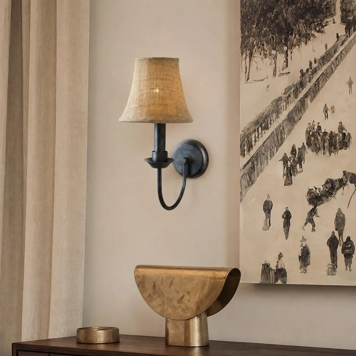 Fabric wall sconce beside framed wall art