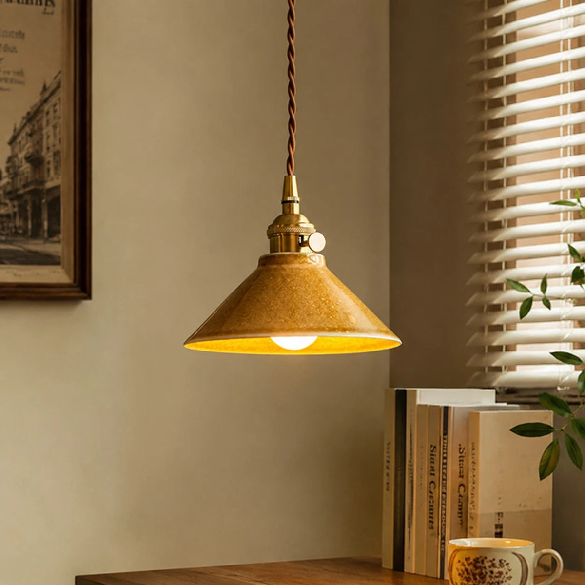 Yellow ceramic pendant light by a warm window corner
