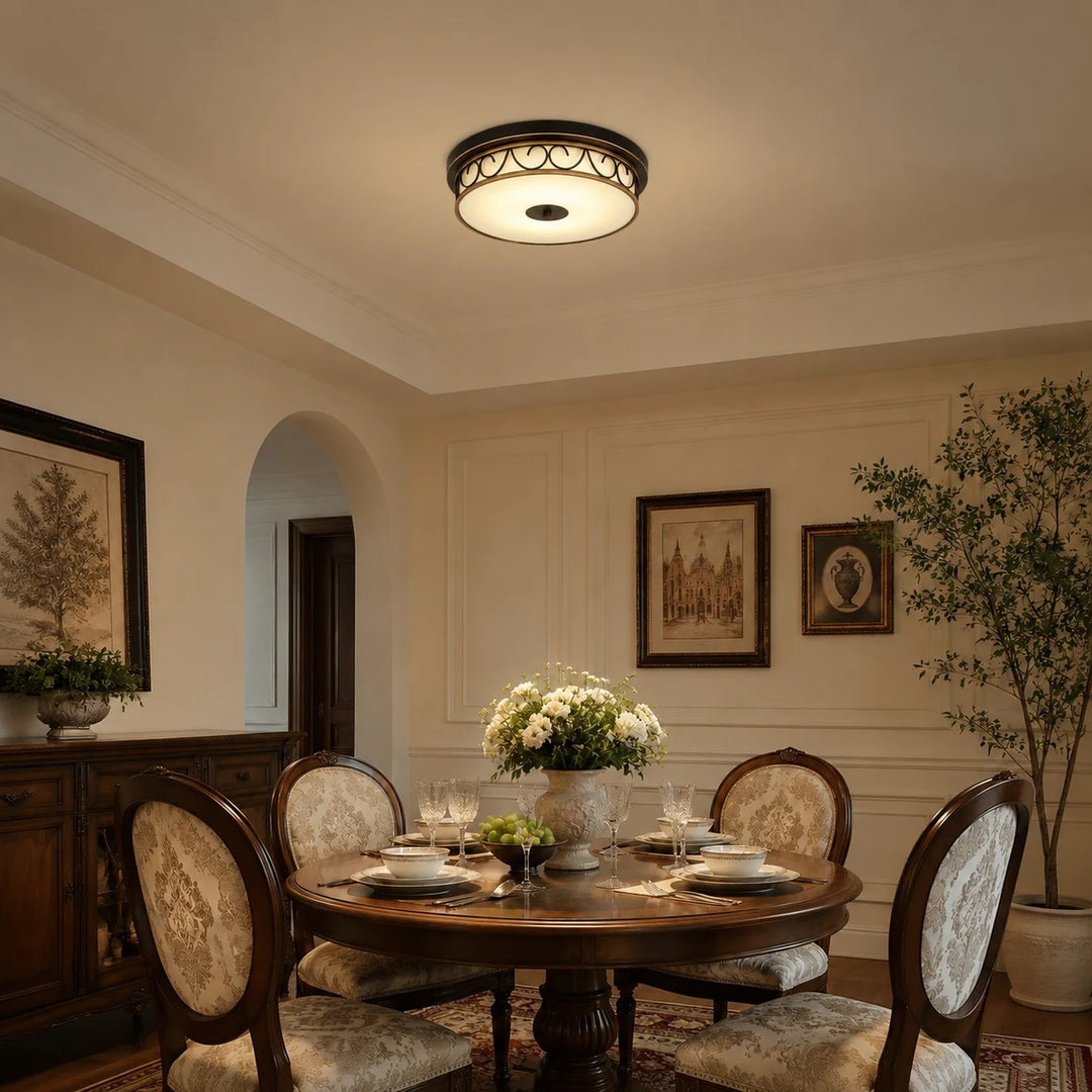 Warm flush mount ceiling light above a dining setting