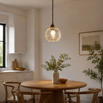 Cargar imagen en el visor de la Galería, clear glass brass pendant light installed above a small dining table