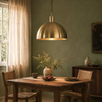 Load image into Gallery viewer, Brass dome pendant light in a warm interior setting