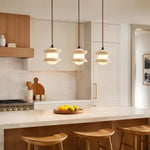 Cargar imagen en el visor de la Galería, Three-light travertine pendant installed above a kitchen island