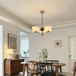Cargar imagen en el visor de la Galería, Cream glass chandelier above a round dining table