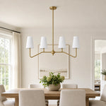 Load image into Gallery viewer, Strellux brass linear chandelier in a dining room setting
