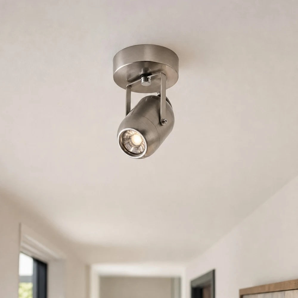 Compact metal wall lamp on a corridor ceiling