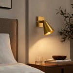 Załaduj obraz do przeglądarki galerii, Brass single-head adjustable wall lamp beside a bed