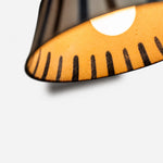 Cargar imagen en el visor de la Galería, Warm light glowing through the striped ceramic shade interior