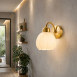 Afbeelding laden in galerijweergave, Milk glass flower wall lamp illuminating a hallway